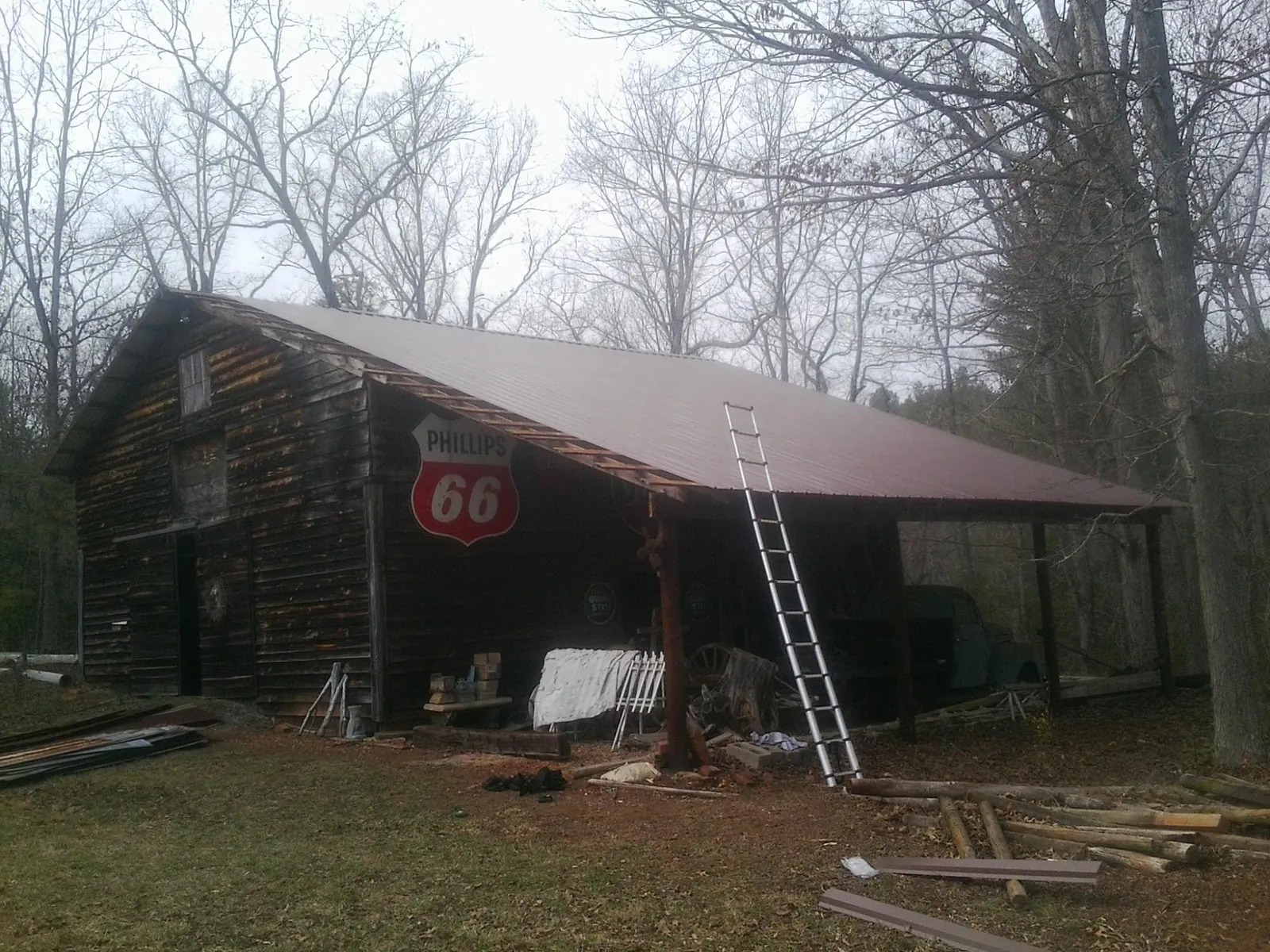 New metal roof on an open sided timber barn with a vintage sign in Hiram